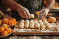Preparing pumpkin gnocchi, rolling on wooden board. Close-up