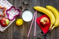 Preparing quick lunch for schoolchild. Fruits on dark wooden table background top view copyspace