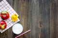 Preparing quick lunch for schoolchild. Fruits on dark wooden table background top view copyspace