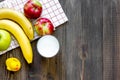 Preparing quick lunch for schoolchild. Fruits on dark wooden table background top view copyspace