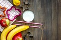 Preparing quick lunch for schoolchild. Fruits on dark wooden table background top view copyspace