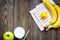 Preparing quick lunch for schoolchild. Fruits on dark wooden table background top view copyspace