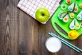 Preparing quick lunch for schoolchild. Funny sandwiches, milk, fruits on dark wooden table background top view copyspace