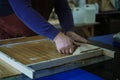 Preparing for the resin pour, an artisan aligns the wood. This step is crucial for achieving a perfect fusion of