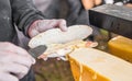 Preparing sandwich at street food market with salmon and raclette melted cheese