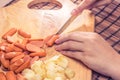 Preparing sausage and vegetables woman hands vintage tone