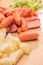 Preparing sausage and vegetables woman hands vintage tone