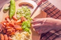 Preparing sausage and vegetables woman hands vintage tone