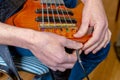 Preparing a six-string bass guitar for playing