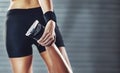 Preparing for some action. Cropped rearview shot of a woman stretching her legs before a gym workout. Royalty Free Stock Photo