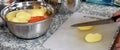 Preparing the soup for lunch begins with chopping the potatoes