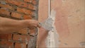Putty application on the wall. Installation of lighthouses on the wall. Wall repair in the apartment. Preparing spackling compound Royalty Free Stock Photo