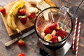 Preparing strawberry and banana smoothie