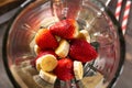 Preparing strawberry and banana smoothie in mixer