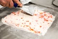 Preparing strawberry rolled ice cream.