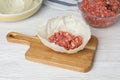 Preparing stuffed cabbage roll on white wooden table Royalty Free Stock Photo