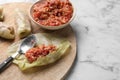 Preparing stuffed cabbage rolls on white marble table. Space for text Royalty Free Stock Photo