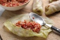 Preparing stuffed cabbage rolls on wooden board, closeup