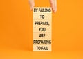 Preparing symbol. Concept words By failing to prepare you are preparing to fail on wooden blocks on a beautiful orange background Royalty Free Stock Photo