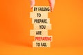 Preparing symbol. Concept words By failing to prepare you are preparing to fail on wooden blocks on a beautiful orange background Royalty Free Stock Photo