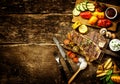 Preparing t-bone steak and roast vegetables