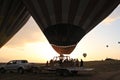 Preparing for take-off hot air balloons with tourists on sunrise Royalty Free Stock Photo