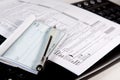 Preparing Taxes - Check and Forms on Keyboard Royalty Free Stock Photo