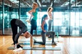 Preparing their bodies in their own individual ways. a group of attractive young women stretching before their yoga