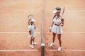 Preparing to big game! Full length top view of a smiling female tennis coach teaching child at clay court before game. Tennis