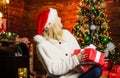 Preparing to Christmas. Christmas time. xmas holiday gift. Decorate christmas tree. cheerful girl red santa hat. happy Royalty Free Stock Photo