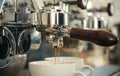 Preparing to perfection. Small cups to serve hot coffee drinks. Coffee cups. Coffee being brewed in coffeehouse or cafe Royalty Free Stock Photo