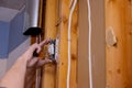 Preparing to remove an electrical outlet of the screws for electrical wires