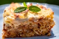Preparing traditional greek food recipe. Baked pasta casserole pastitsio with rich bechamel sauce and ground beef