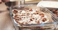 Preparing traditional italian lasagna adding cheese Royalty Free Stock Photo