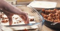 Preparing traditional italian lasagna adding pasta