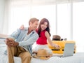 Preparing trip and vacation plan concepts. Young pretty Asian woman and man in denim shirt looking at the laptop and map. Royalty Free Stock Photo