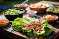 preparing turkey lettuce wraps at an outdoor picnic Royalty Free Stock Photo