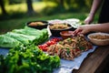 preparing turkey lettuce wraps at an outdoor picnic