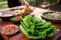 preparing turkey lettuce wraps at an outdoor picnic Royalty Free Stock Photo