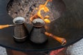 Preparing Turkish coffee with black cezve or ibrik at street food festival