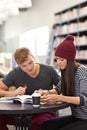 Preparing for the upcoming exams. two college students studying together at the library. Royalty Free Stock Photo