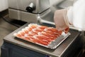 Preparing a vacuum packed ham board Royalty Free Stock Photo