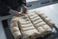 preparing a vacuumsealed bag with a puffer jacket for dispatch Royalty Free Stock Photo