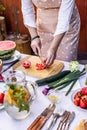 Woman chopping red tomato on cutting board Royalty Free Stock Photo