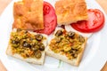 Preparing vegetarian sandwiches with pickle muffaletta, tomatoes Royalty Free Stock Photo