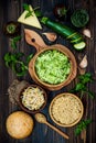 Preparing veggies cutlets or patties for burgers. Zucchini quinoa veggie burger with pesto sauce and sprouts. Top view, overhead Royalty Free Stock Photo