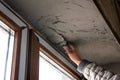 Repair in the slopes of the window. The process of applying a layer of plaster on the sides of the