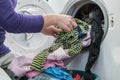 Preparing the wash cycle. Washing machine, hands and clothes. Royalty Free Stock Photo