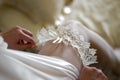 Bride puts on a garter of the bride Royalty Free Stock Photo