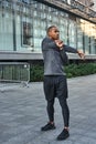 Preparing for workout. Full length portrait of african athlete stretching his arms during morning workout